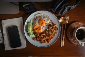 Fried eggs and stir-fried chicken with basil photo
