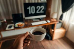 Cup of coffee in a mug at your desk in the mornin photo