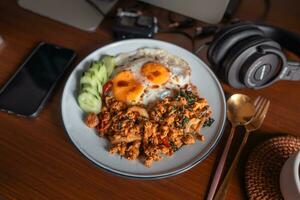 Fried eggs and stir-fried chicken with basil photo