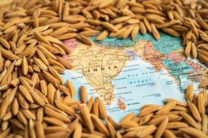 Bangkok, Thailand May 14, 2023 Brown rice paddy seeds on India map, India rice export ban trigger a global food crisis concept. photo