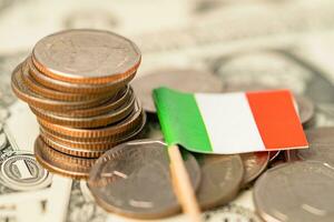 Stack of coins with Italy flag and US dollar banknotes. photo