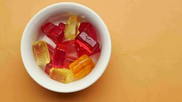 colorful candy sweet jelly in a bowl on table video