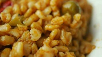 bulgur rice with tomato on a plate , video