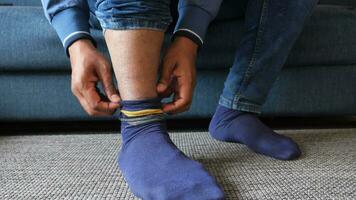 man feet in light socks sitting on sofa video