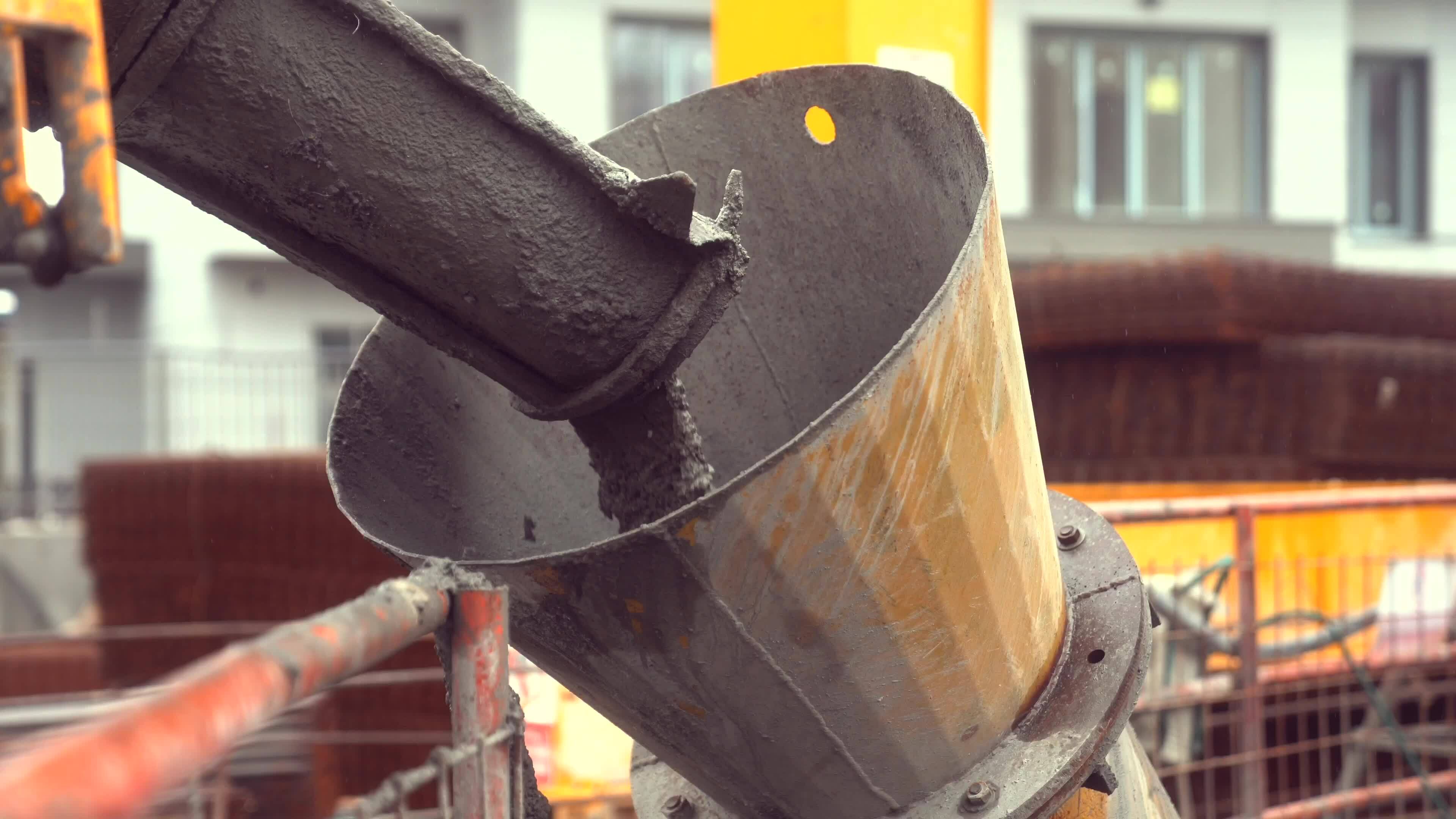 a bucket of concrete being poured into a bucket 30932319 Stock Video at
