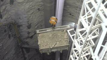 rubble removed from the subway tunnel shaft with the help of a crane, excavation video