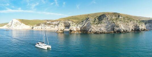 People at Most Beautiful High Angle View of British Landscape and Sea View of Durdle Door Beach of England Great Britain, UK. Image Was captured with Drone's camera on September 9th, 2023 photo