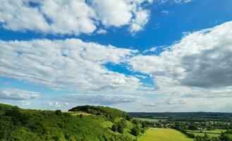 Most Beautiful High Angle view of Dramatical Sky and Clouds over British Countryside Landscape During Sunset photo