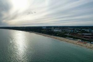 Aerial View of Most Beautiful and Attractive Tourist Destination at Bournemouth City Sandy Beach of England Great Britain, Image Was Captured with Drone's Camera on August 23rd, 2023 During sunny Day. photo