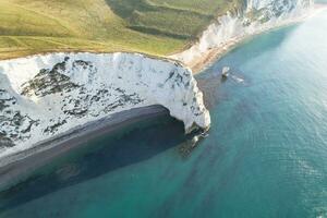 Most Beautiful View of British Landscape and Sea View of Durdle Door Beach of England Great Britain, UK. Image Was captured with Drone's camera on September 9th, 2023 photo