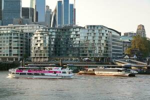 Best View of Boat over River Thames Waters at London Bridge, Capital City of England Great Britain. The Image Was Captured June 4th, 2023 photo