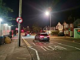 Low Angle View of Illuminated Road and Car Park Building Opposite of Luton and Dunstable Hospital at Luton City of England UK During night of Sep 3rd, 2023. photo