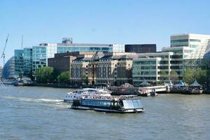 Best View of Boat over River Thames Waters at London Bridge, Capital City of England Great Britain. The Image Was Captured June 4th, 2023 photo