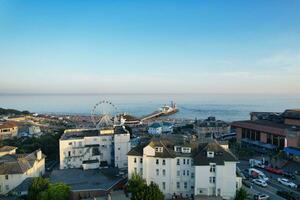 Aerial View of British Tourist Attraction of Bournemouth Beach and Sea view City of England Great Britain UK. Image Captured with Drone's Camera on September 9th, 2023 During Sunset photo