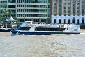 Best View of Boat over River Thames Waters at London Bridge, Capital City of England Great Britain. The Image Was Captured June 4th, 2023 photo