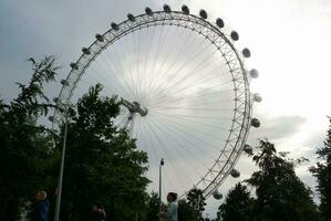 Beautiful Low Angle Image of People at Central London capital City of England Great Britain, Most of the Tourist are International from Many Communities of World. Image Captured on August 2nd, 2023 photo