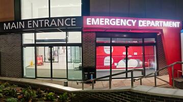 Low Angle Illuminated View of Emergency Entrance of Luton and Dunstable Hospital at Luton City of England UK During Midnight of Sep 3rd, 2023. Hospital's Building is Under construction for Renovation photo