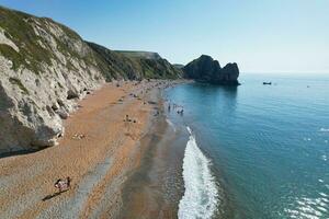 Best Aerial Footage of People are Enjoying Boat Ride at Gorgeous British Tourist Attraction and Ocean Sea View of Durdle Door Beach of England UK. Captured with Drone's Camera on September 9th, 2023 photo