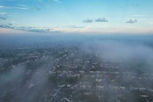 Most Beautiful and Best High Angle Dramatical Colourful Sky Footage from Above The Clouds. The Fast Moving Clouds During Sun rising Early in the Morning over Luton City of England UK photo