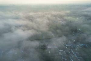 Most Beautiful and Best High Angle Dramatical Colourful Sky Footage from Above The Clouds. The Fast Moving Clouds During Sun rising Early in the Morning over Luton City of England UK photo