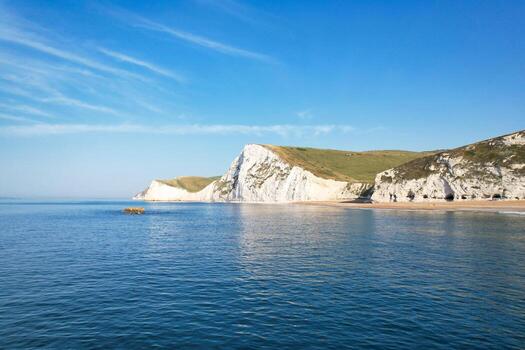 Most Beautiful View of British Landscape and Sea View of Durdle Door Beach of England Great Britain, UK. Image Was captured with Drone's camera on September 9th, 2023 photo