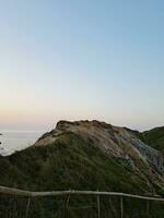 High Angle View of People are Approaching to Durdle Door Beach Which is Most Famous Tourist Attraction Place Through Walking Distance over Landscape and Hills. Captured on September 9th, 2023 photo