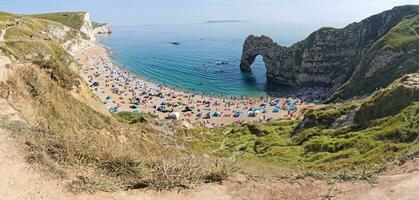 Most Beautiful High Angle View of British Landscape and Sea View of Durdle Door Beach of England Great Britain, UK. Image Was captured with Drone's camera on September 9th, 2023 photo