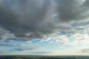 Most Beautiful High Angle view of Dramatical Sky and Clouds over British Countryside Landscape During Sunset photo