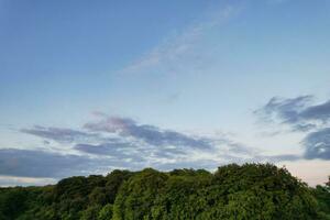 Most Beautiful High Angle view of Dramatical Sky and Clouds over British Countryside Landscape During Sunset photo