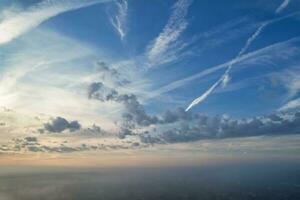 Most Beautiful and Best High Angle Dramatical Colourful Sky Footage from Above The Clouds. The Fast Moving Clouds During Sun rising Early in the Morning over Luton City of England UK photo