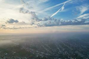 Most Beautiful and Best High Angle Dramatical Colourful Sky Footage from Above The Clouds. The Fast Moving Clouds During Sun rising Early in the Morning over Luton City of England UK photo