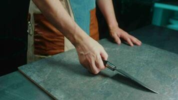 The cook in the apron tosses and twirls the knife in his hands video