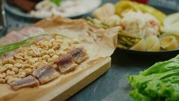 pickled vegetables on a plate and peanuts and wobble on a plate video