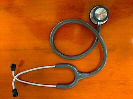 top view of Stethoscope on wooden table background. Concept of health and medicine. National Health Day concept. photo