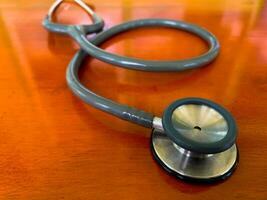 closeup of Stethoscope on wooden table background. Concept of health and medicine. National Health Day concept. photo