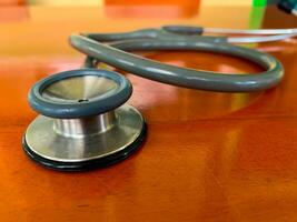 closeup of Stethoscope on wooden table background. Concept of health and medicine. National Health Day concept. photo
