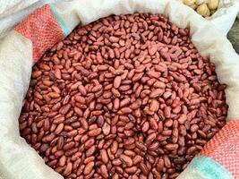 red kidney beans in sacks for sale in bulk at local flea markets grown in a nearby garden photo