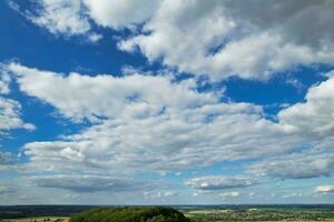 Most Beautiful High Angle view of Dramatical Sky and Clouds over British Countryside Landscape During Sunset photo