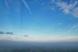 Most Beautiful and Best High Angle Dramatical Colourful Sky Footage from Above The Clouds. The Fast Moving Clouds During Sun rising Early in the Morning over Luton City of England UK photo