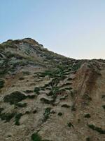 High Angle View of People are Approaching to Durdle Door Beach Which is Most Famous Tourist Attraction Place Through Walking Distance over Landscape and Hills. Captured on September 9th, 2023 photo