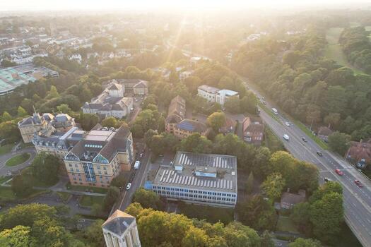 Aerial View of British Tourist Attraction of Bournemouth Beach and Sea view City of England Great Britain UK. Image Captured with Drone's Camera on September 9th, 2023 During Sunset photo