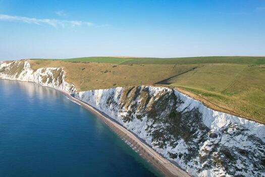 Most Beautiful View of British Landscape and Sea View of Durdle Door Beach of England Great Britain, UK. Image Was captured with Drone's camera on September 9th, 2023 photo