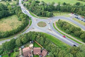 High Angle Footage of British Road and Traffic at Caldecotte Lake of Milton Keynes City of England Great Britain, Beautiful View Captured on August 21st, 2023 with Drone's Camera During Sunny Day photo