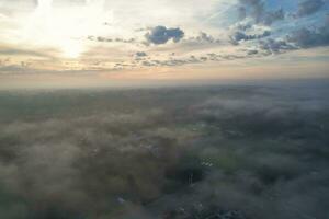 Most Beautiful and Best High Angle Dramatical Colourful Sky Footage from Above The Clouds. The Fast Moving Clouds During Sun rising Early in the Morning over Luton City of England UK photo