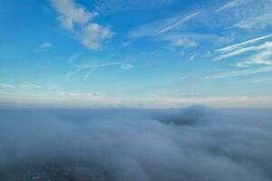 Most Beautiful and Best High Angle Dramatical Colourful Sky Footage from Above The Clouds. The Fast Moving Clouds During Sun rising Early in the Morning over Luton City of England UK photo