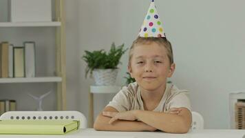 a boy with a party hat holding a blank card video