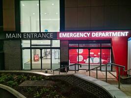 Low Angle Illuminated View of Emergency Entrance of Luton and Dunstable Hospital at Luton City of England UK During Midnight of Sep 3rd, 2023. Hospital's Building is Under construction for Renovation photo