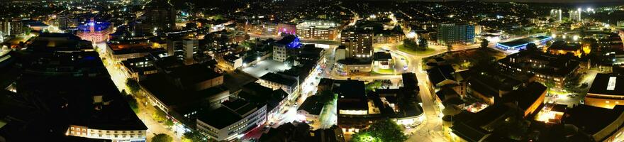 Ultra Wide Aerial Panoramic View of Illuminated Downtown Buildings, Roads and Central Luton City of England UK at Beginning of Clear Weather's Night of September 5th, 2023 photo