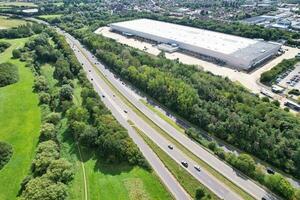 High Angle Footage of British Road and Traffic at Caldecotte Lake of Milton Keynes City of England Great Britain, Beautiful View Captured on August 21st, 2023 with Drone's Camera During Sunny Day photo