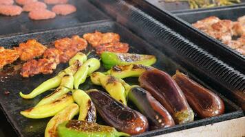 Beef and chicken steaks on the grill with flames. video